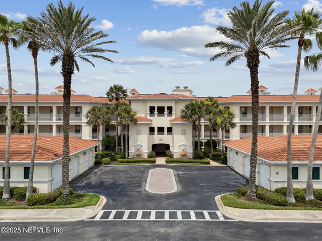 a view of a lake in between two large trees