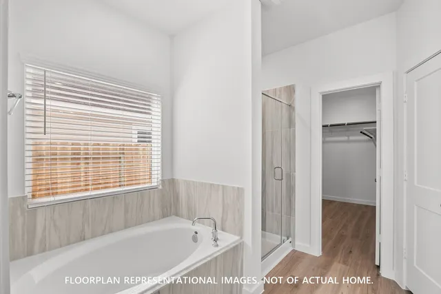 a spacious bathroom with a double vanity sink a mirror and shower