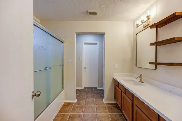 a bathroom with a double vanity sink and mirror