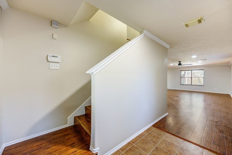 11010 Crosby Field Lane Houston, TX 77034 - Photo 2 of 15 a view of a hallway with wooden floor and staircase