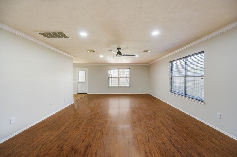 11010 Crosby Field Lane Houston, TX 77034 - Photo 3 of 15 an empty room with wooden floor and windows