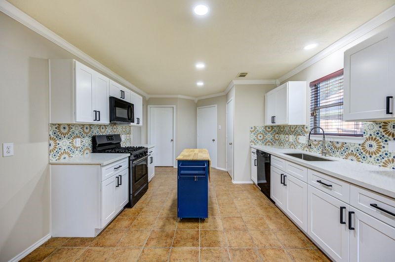 11010 Crosby Field Lane Houston, TX 77034 - Photo 4 of 15 a kitchen with stainless steel appliances granite countertop a stove top oven a sink dishwasher and a refrigerator with wooden floor