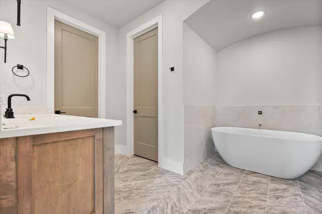 a bathroom with a bathtub and shower