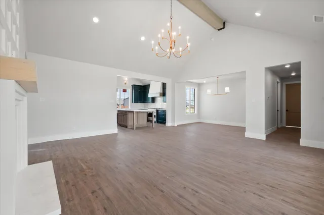 a view of a livingroom with a furniture a fireplace and wooden floor