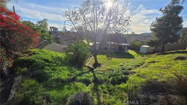 a large green building with trees in front of it