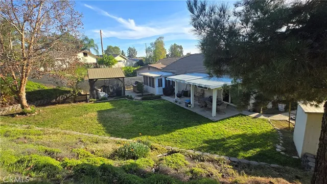 a view of a house with a yard porch and sitting area