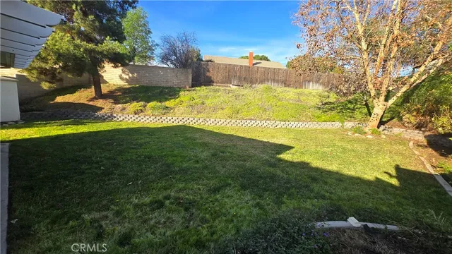 a view of an ocean a building in the background