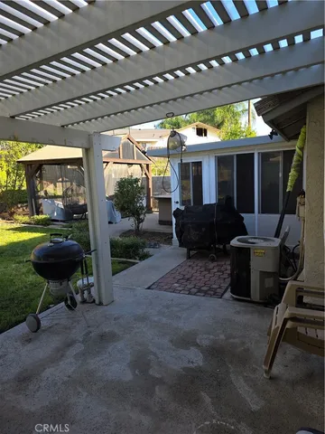 a view of a porch with furniture and a yard