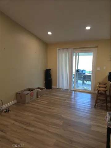 a room with wooden floor and furniture