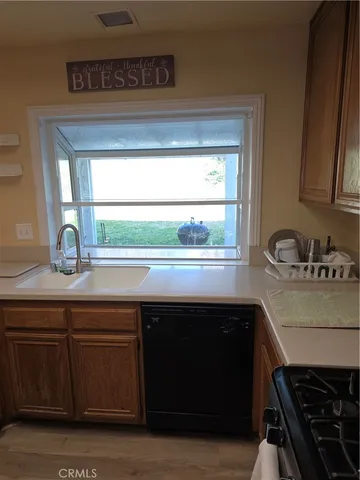 a kitchen with a sink a stove and cabinets