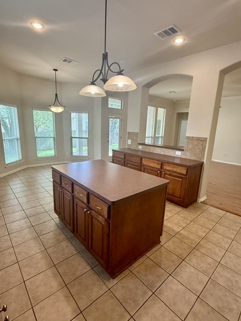 20724 Kearney Hill Road Pflugerville, TX 78660 - Photo 16 of 40 Spacious kitchen featuring a central island, extensive cabinetry, tile flooring, and integrated lighting