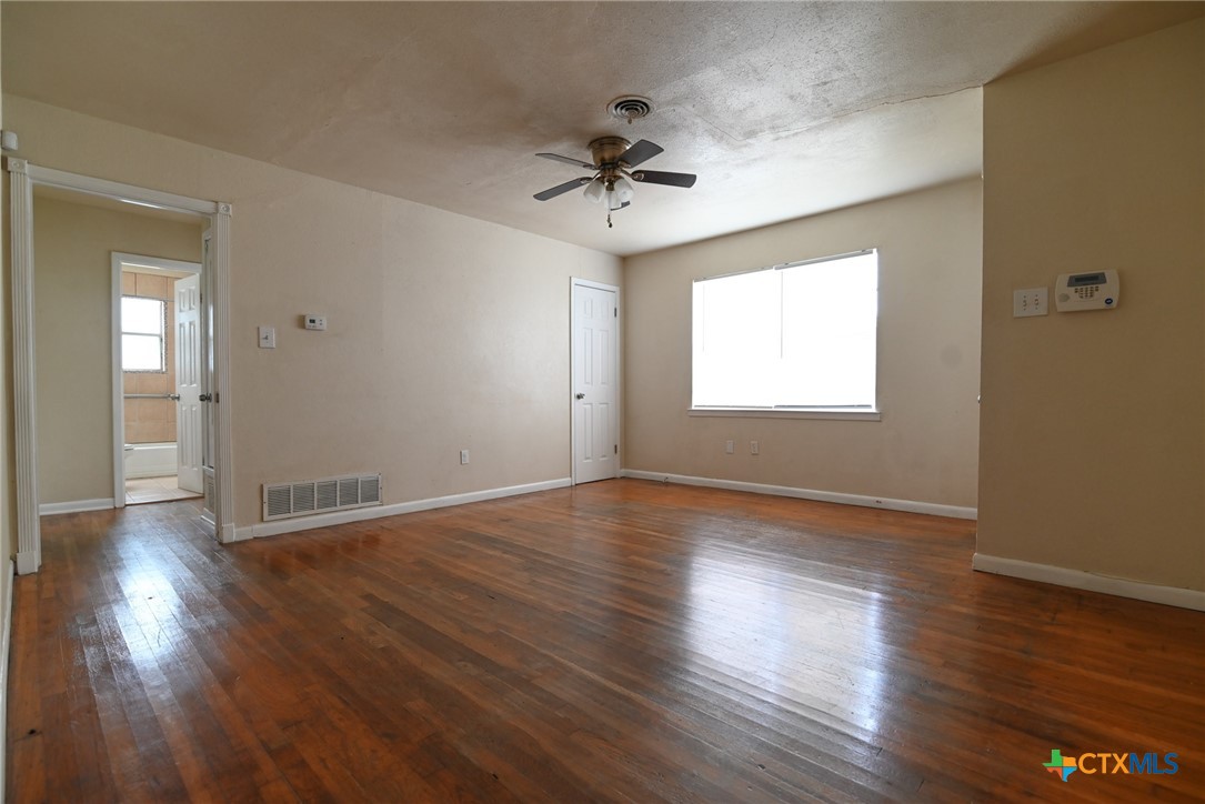 707 South 5th Street Copperas Cove, TX 76522 - Photo 4 of 19 a view of an empty room with wooden floor and a window