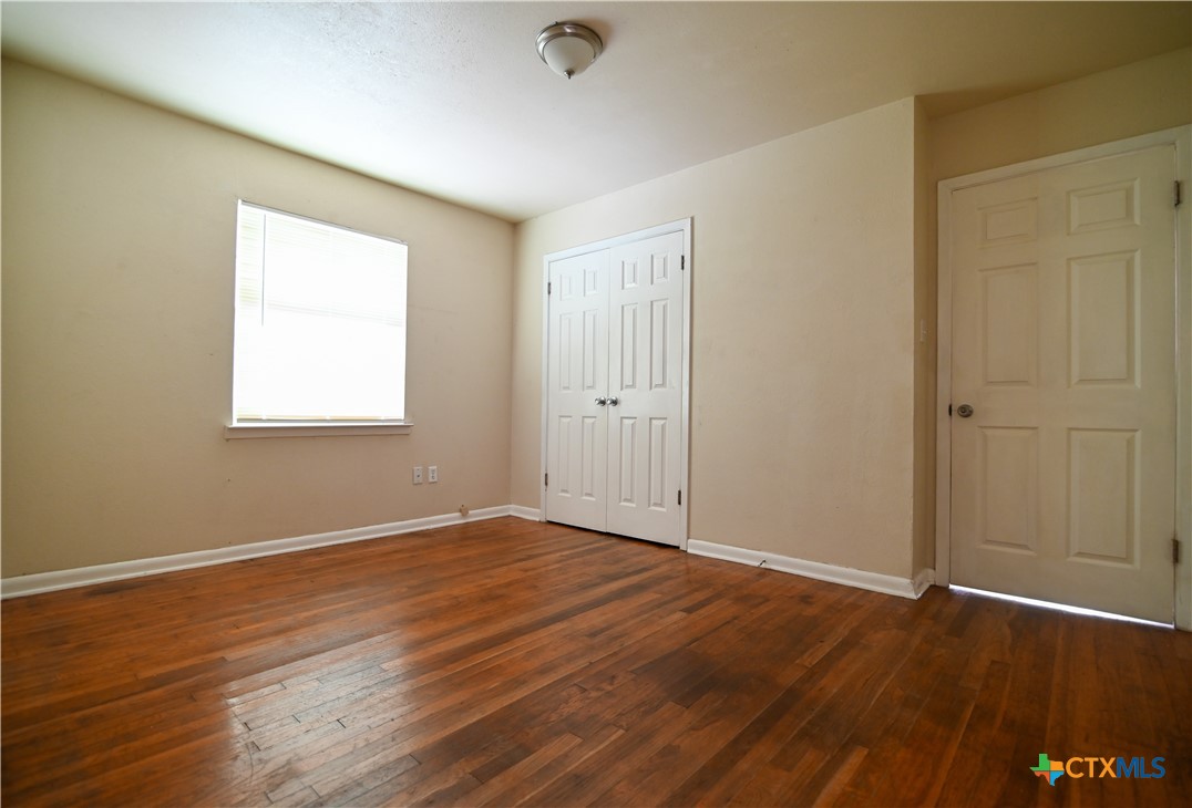 707 South 5th Street Copperas Cove, TX 76522 - Photo 6 of 19 a view of an empty room with wooden floor and a window