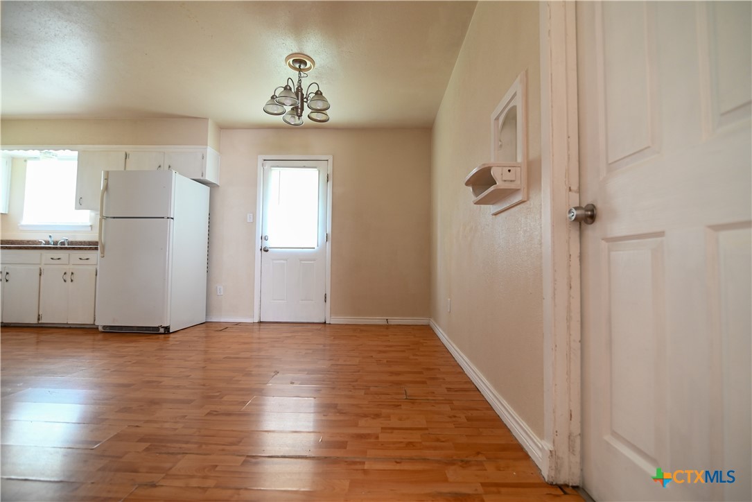 707 South 5th Street Copperas Cove, TX 76522 - Photo 9 of 19 an empty room with wooden floor and windows