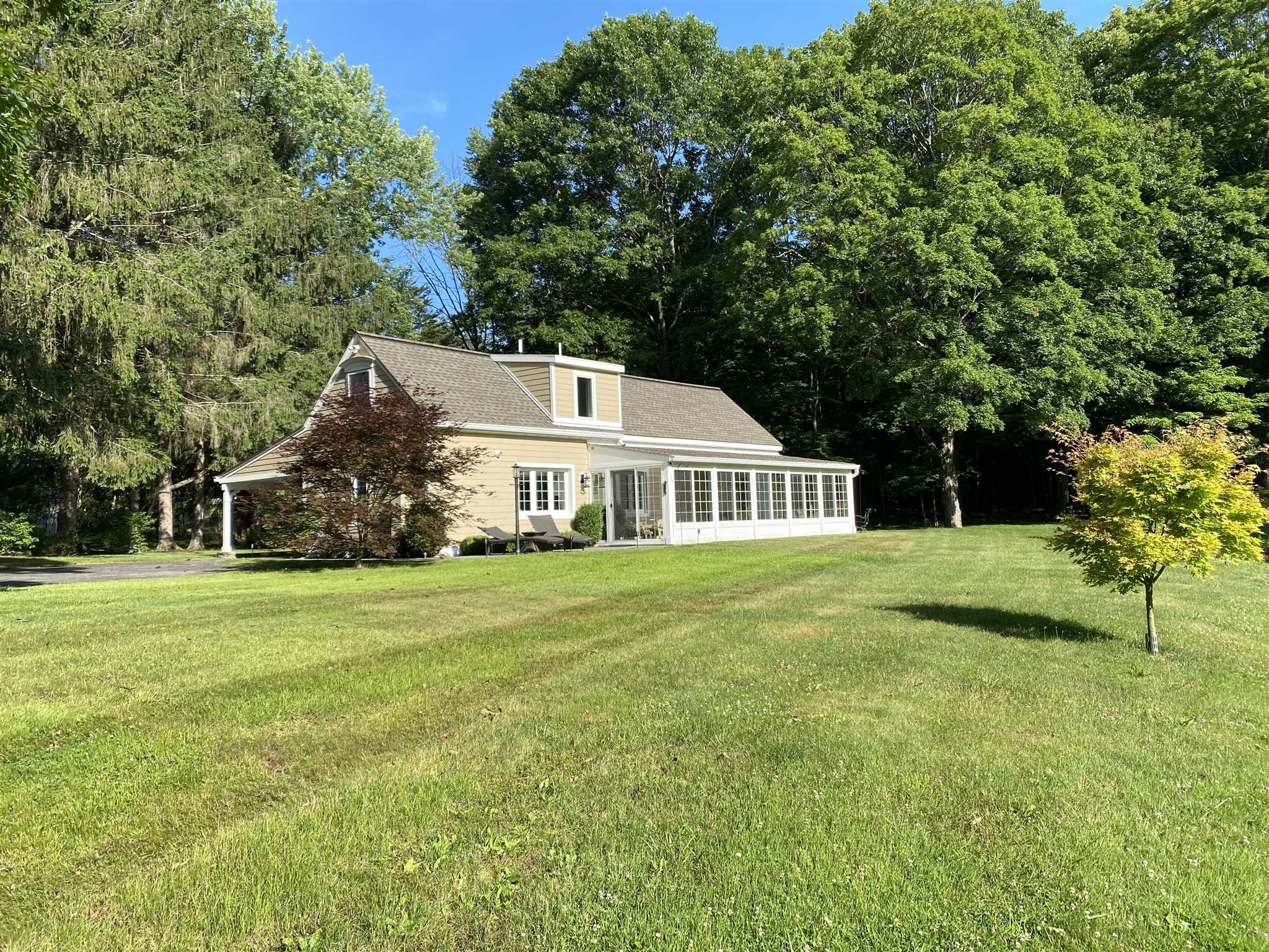 a front view of a house with a garden