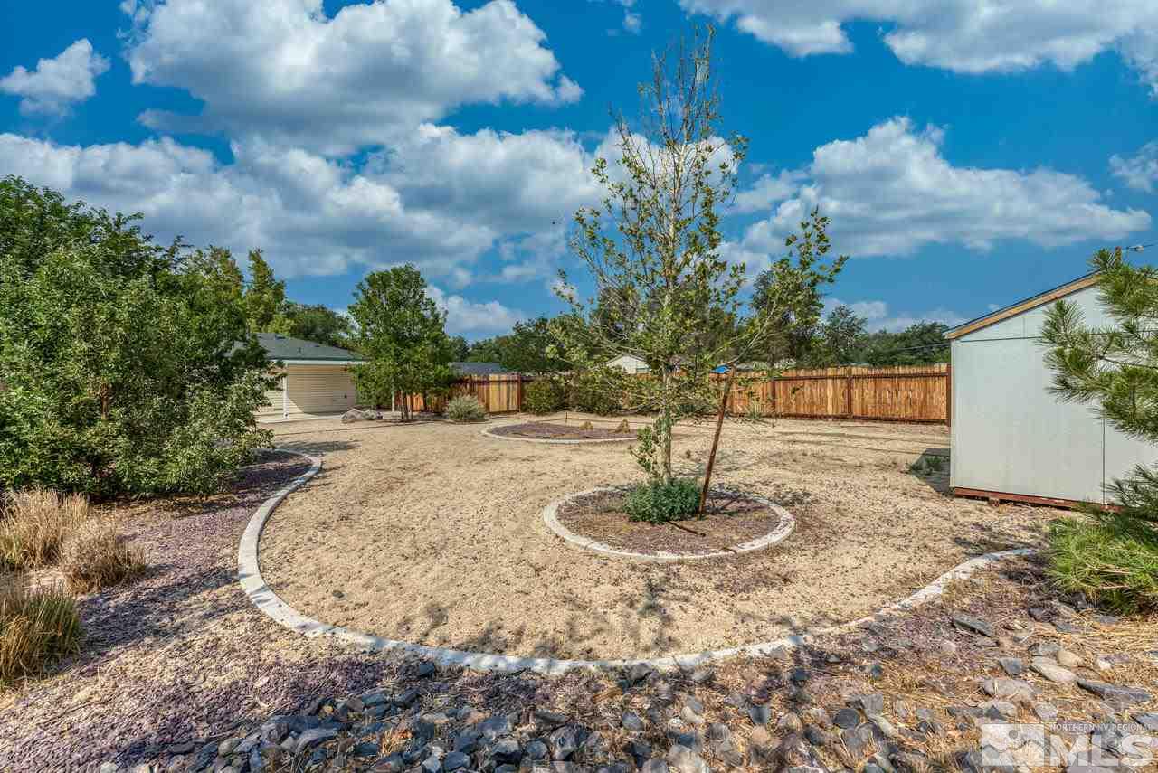 1890 Helena Avenue Reno, NV 89512 - Photo 21 of 23 a backyard of a house with a yard and fountain