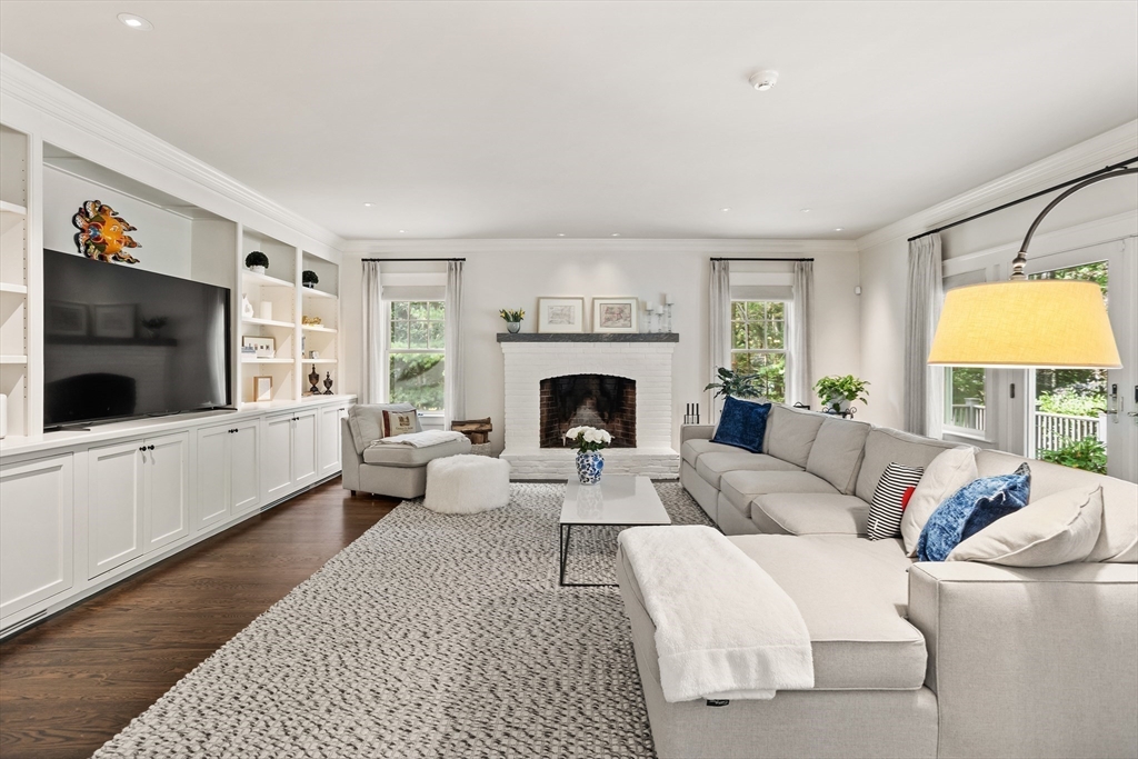 244 Musterfield Road Concord, MA 01742 - Photo 11 of 41 a living room with furniture a flat screen tv and a fireplace