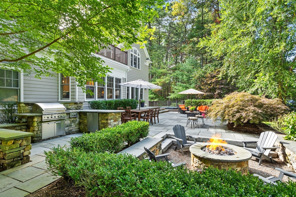 244 Musterfield Road Concord, MA 01742 - Photo 2 of 41 a backyard of a house with lots of green space and fountain