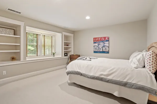 a spacious bathroom with a shower a sink and a mirror