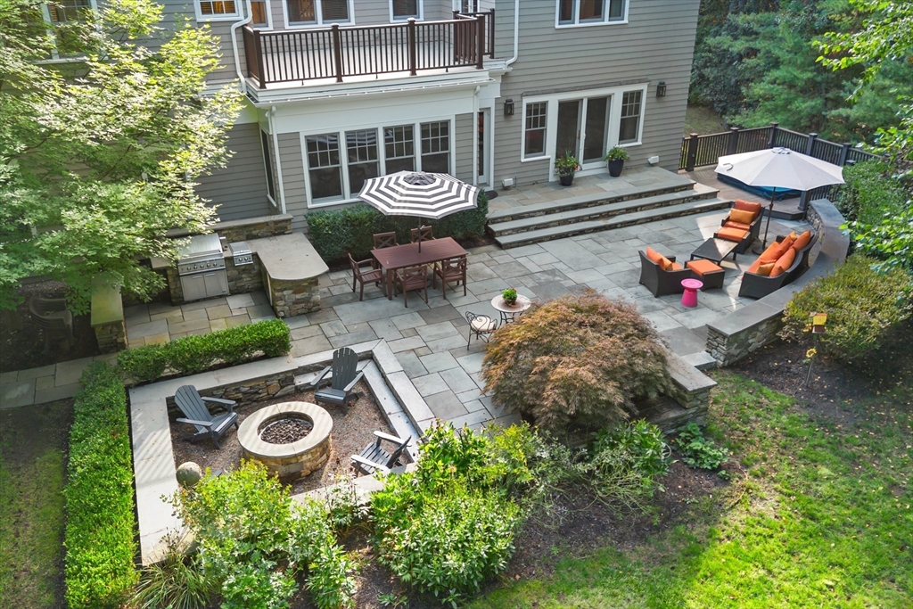 244 Musterfield Road Concord, MA 01742 - Photo 35 of 41 a view of a backyard with table and chairs and potted plants