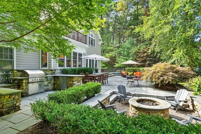 a view of a patio with couches and table and chairs under an umbrella