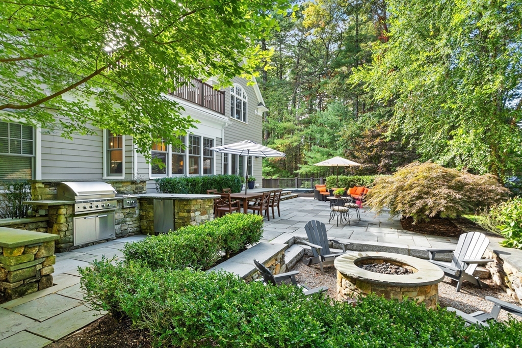244 Musterfield Road Concord, MA 01742 - Photo 36 of 41 a backyard of a house with chairs and a fire pit