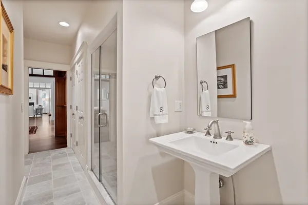 a bathroom with a sink a toilet and shower
