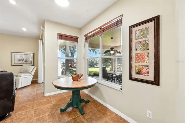 a living room with furniture and a painting on the wall