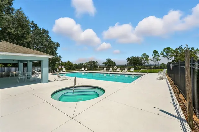 a swimming pool with outdoor seating yard and barbeque oven