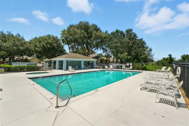 a view of a swimming pool with a yard