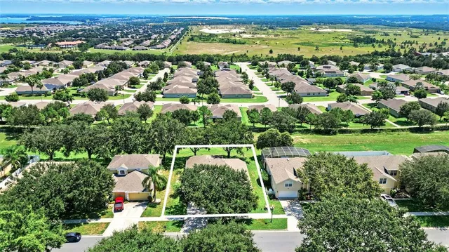 an aerial view of a city with lots of residential buildings and mountain view in back