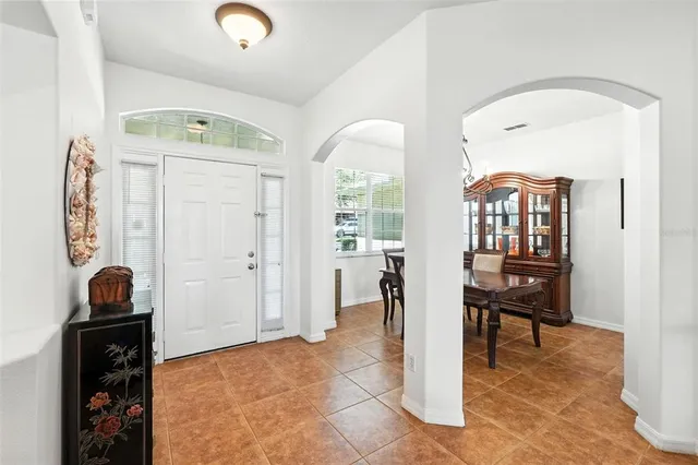 a view of a hallway with workspace and a living room