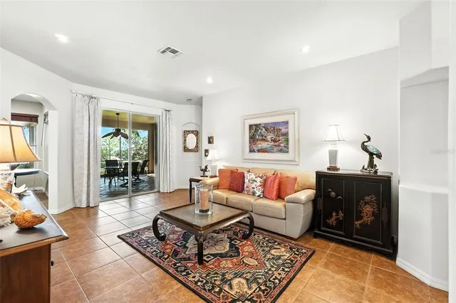 a living room with furniture a rug and a large window