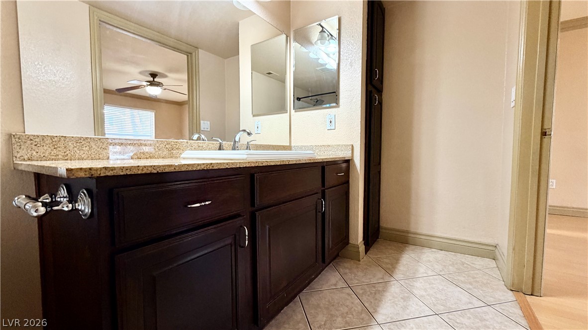 8101 West Flamingo Road, Unit 1082 Las Vegas, NV 89147 - Photo 23 of 23 Ample counter space and integrated sink create a functional and orderly vanity in this well-appointed bathroom.