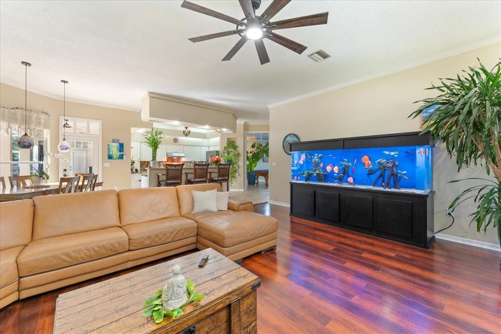 13624 Cooper Road Spring Hill, FL 34609 - Photo 24 of 75 a living room with furniture and a flat screen tv