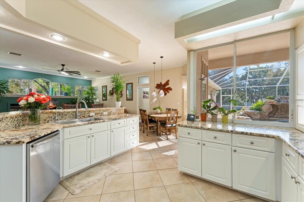 13624 Cooper Road Spring Hill, FL 34609 - Photo 3 of 75 a kitchen with lots of counter top space sink and glass door