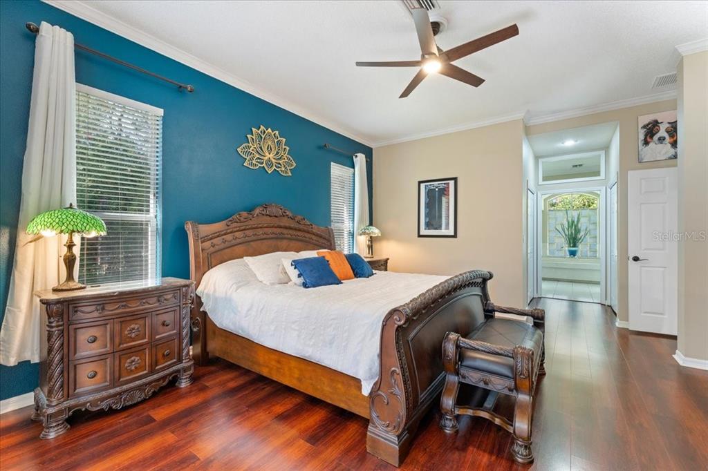 13624 Cooper Road Spring Hill, FL 34609 - Photo 32 of 75 a bedroom with a bed and wooden floor