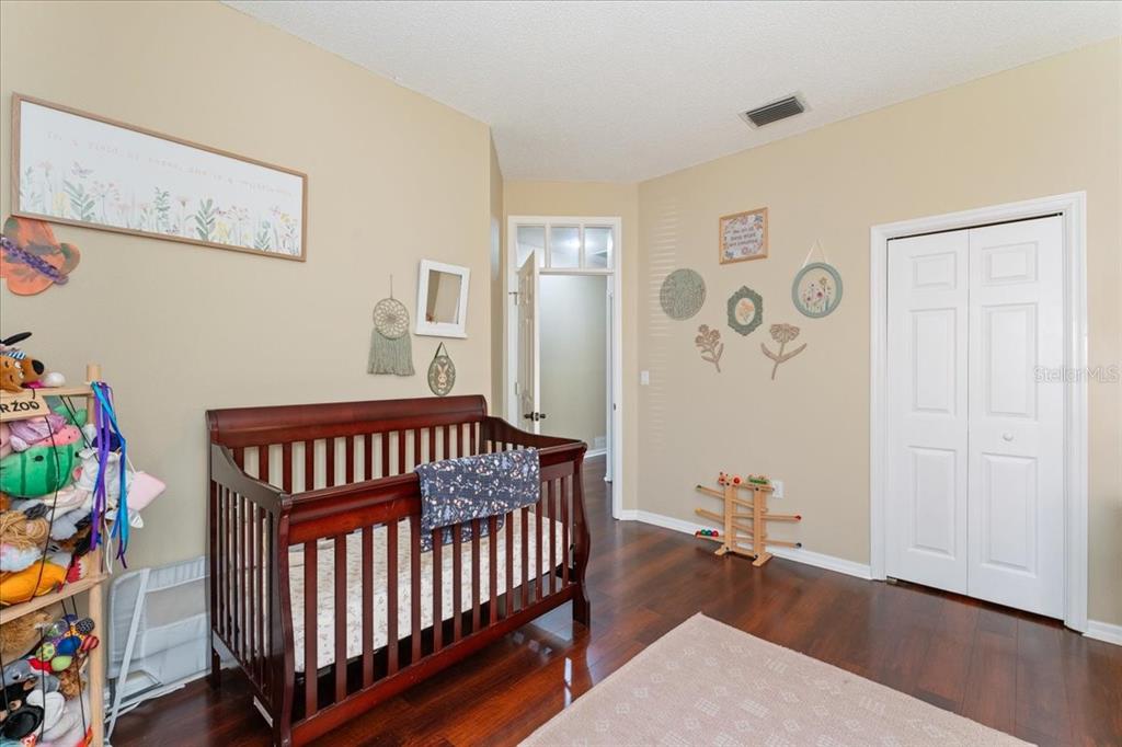 13624 Cooper Road Spring Hill, FL 34609 - Photo 42 of 75 a bedroom with furniture and wooden floor
