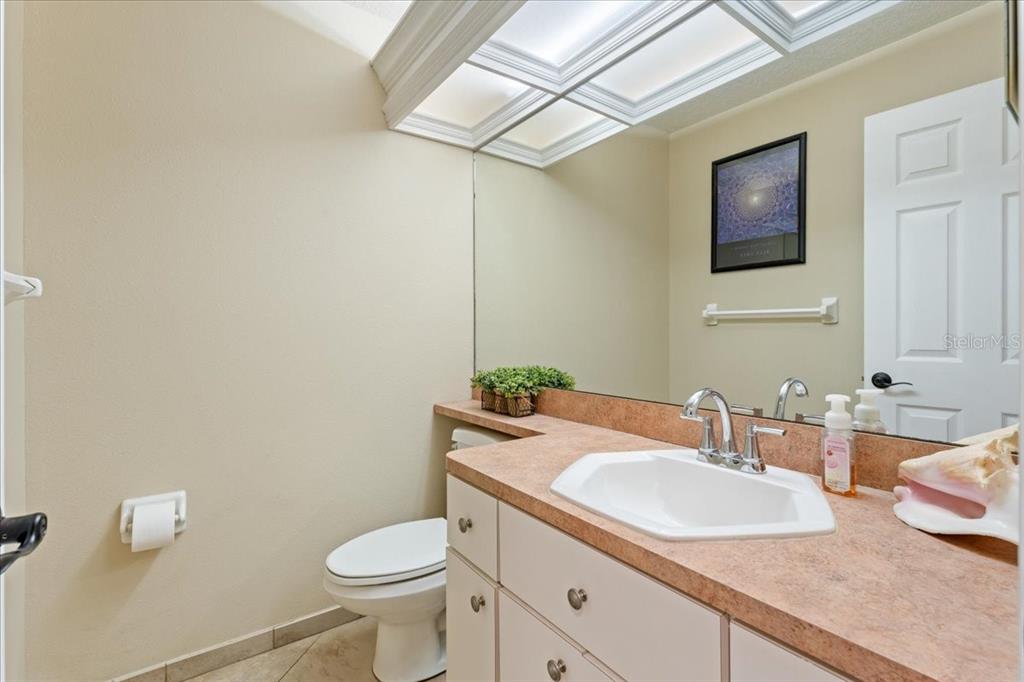 13624 Cooper Road Spring Hill, FL 34609 - Photo 43 of 75 a bathroom with a granite countertop toilet sink and mirror