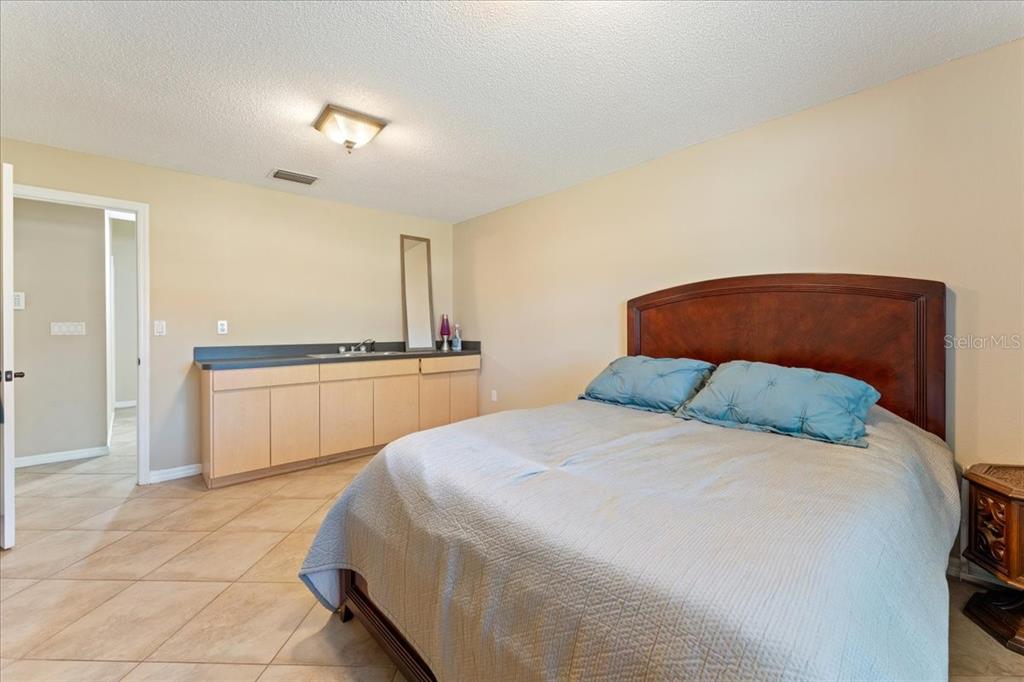 13624 Cooper Road Spring Hill, FL 34609 - Photo 46 of 75 a bedroom with a bed and a sink