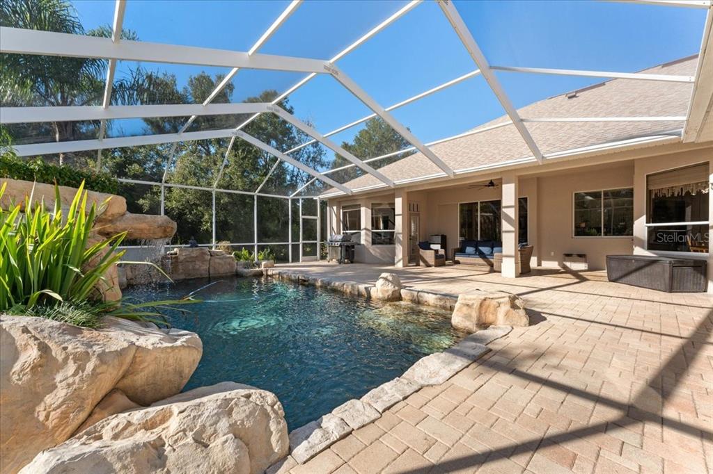 13624 Cooper Road Spring Hill, FL 34609 - Photo 51 of 75 a view of a backyard with couches chair and potted plants
