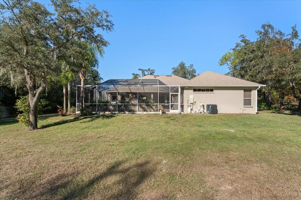 13624 Cooper Road Spring Hill, FL 34609 - Photo 57 of 75 a front view of a house with a garden