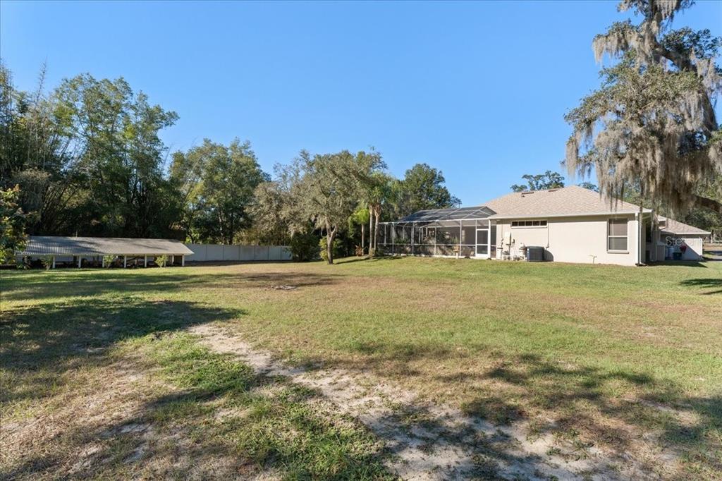 13624 Cooper Road Spring Hill, FL 34609 - Photo 59 of 75 a front view of house with yard and trees