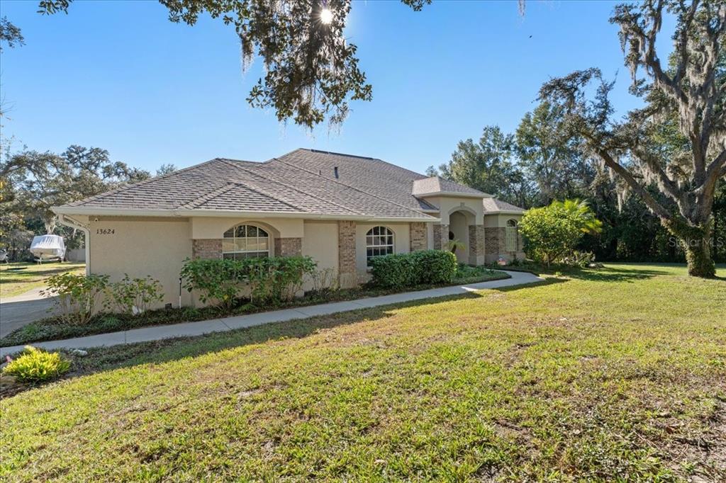 13624 Cooper Road Spring Hill, FL 34609 - Photo 63 of 75 a front view of house with yard and swimming pool