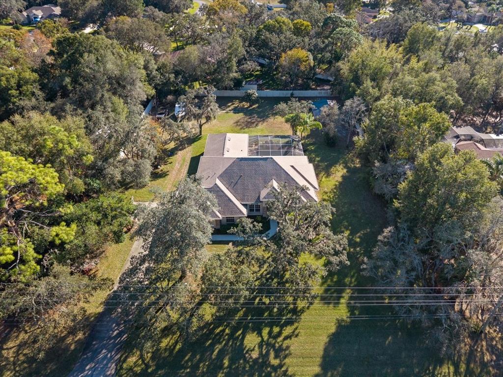 13624 Cooper Road Spring Hill, FL 34609 - Photo 65 of 75 an aerial view of house with yard swimming pool and outdoor seating