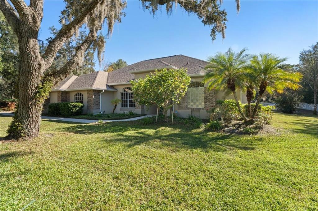 13624 Cooper Road Spring Hill, FL 34609 - Photo 68 of 75 a view of a house with a yard