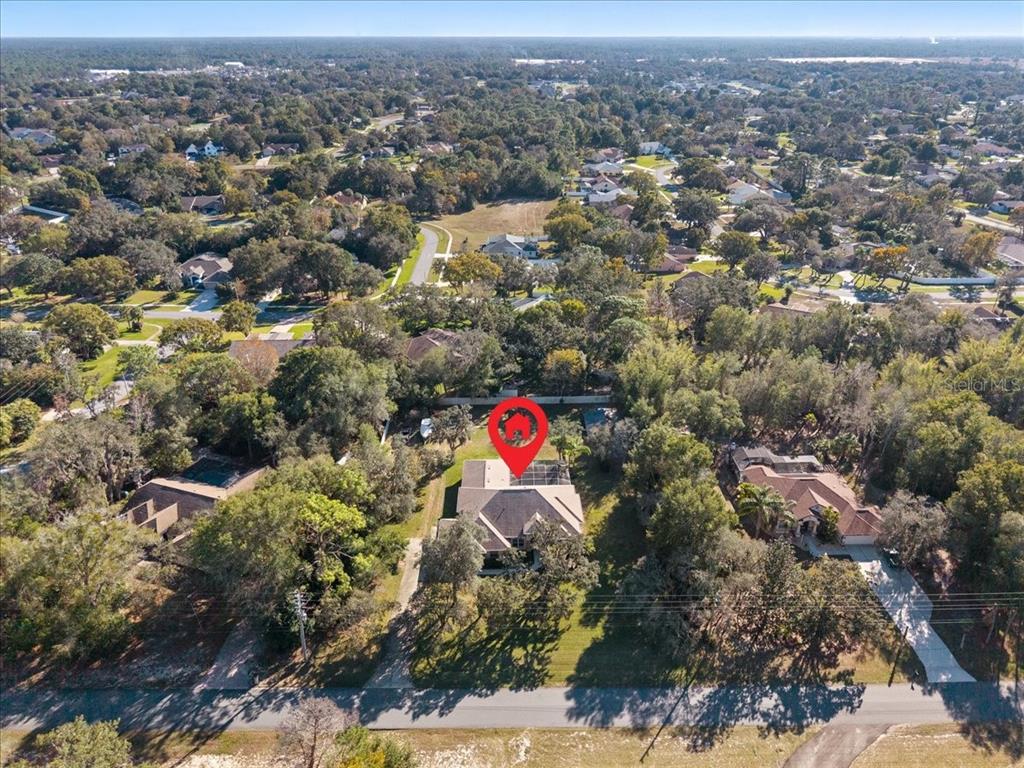 13624 Cooper Road Spring Hill, FL 34609 - Photo 70 of 75 an aerial view of residential house with outdoor space and trees
