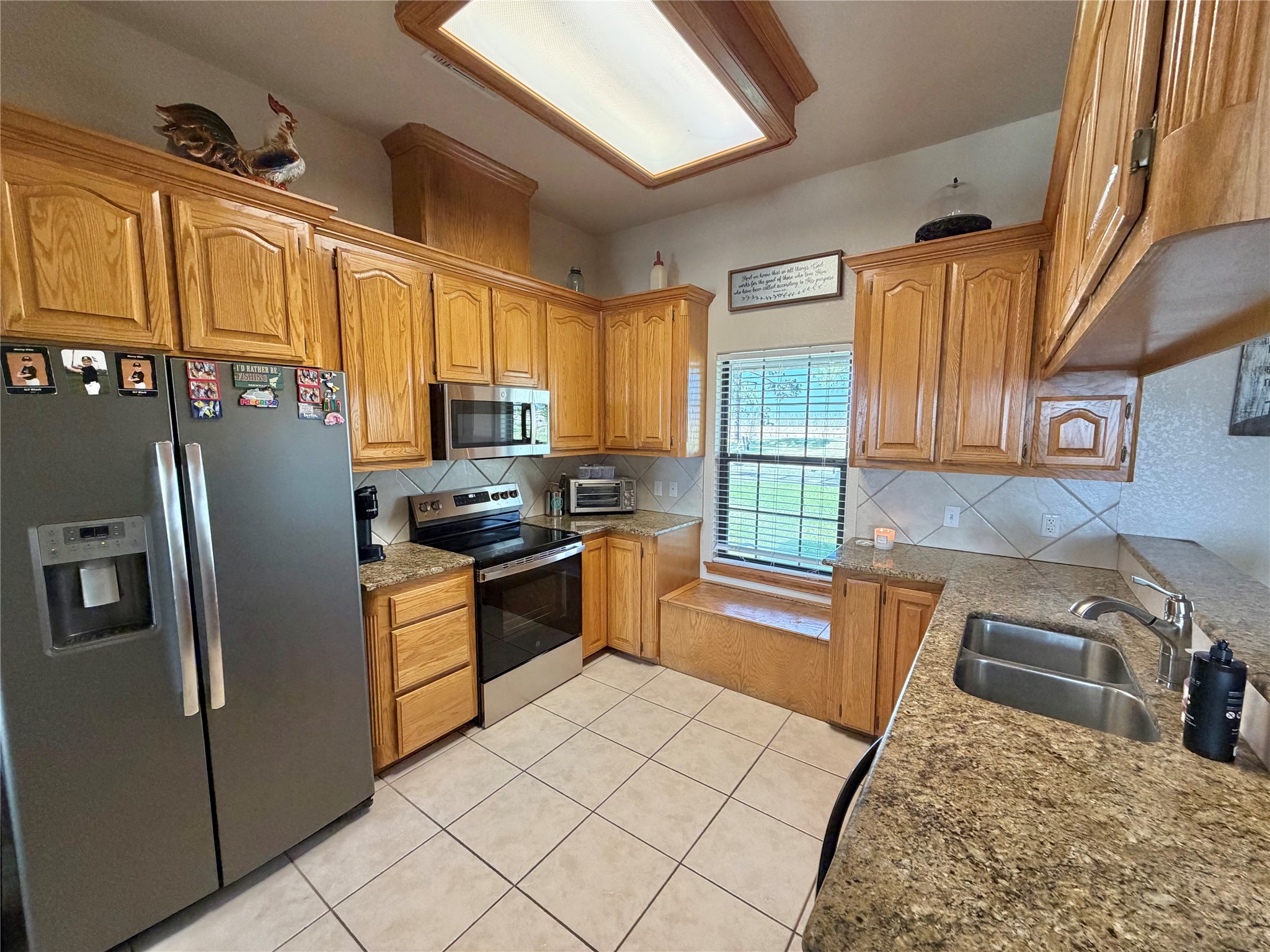 15903 County Road 621 Angleton, TX 77515 - Photo 11 of 33 a kitchen with stainless steel appliances granite countertop a refrigerator a stove top oven a sink and dishwasher