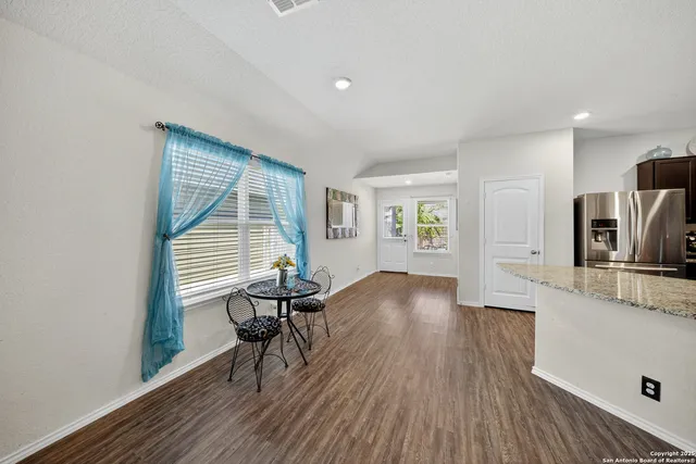 a view of a room with wooden floor and windows