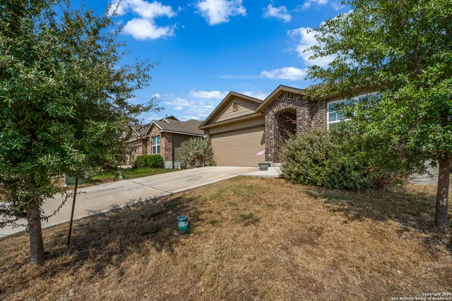 a view of a house with a yard and garage